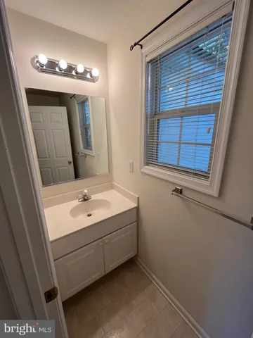 a bathroom with a sink a vanity and a mirror