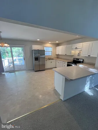 a kitchen with stainless steel appliances a refrigerator sink and cabinets
