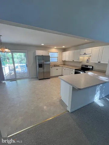 a kitchen with stainless steel appliances a refrigerator sink and cabinets