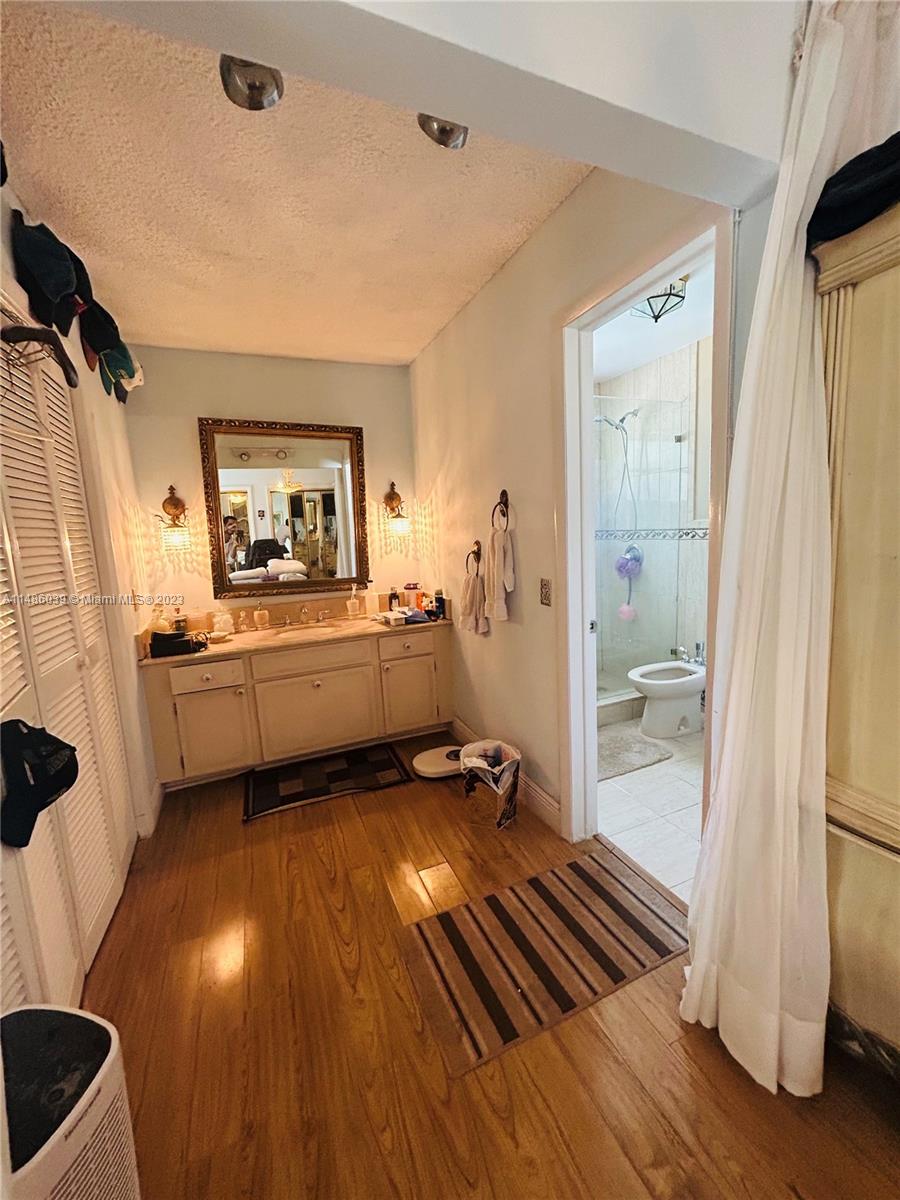 2311 Southwest 23rd Street Miami, FL 33145 - Photo 13 of 21 a bathroom with a sink a mirror and a shower