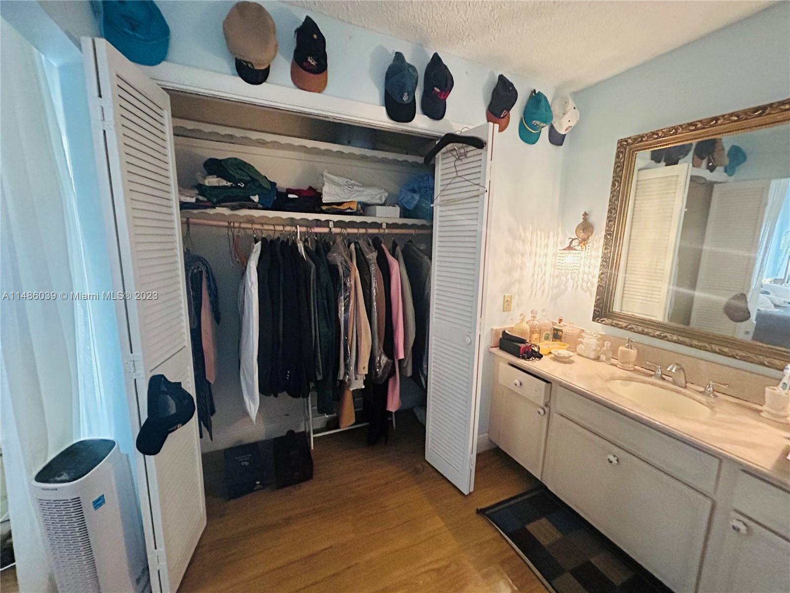 2311 Southwest 23rd Street Miami, FL 33145 - Photo 15 of 21 a view of walk in closet with clothes and shoes