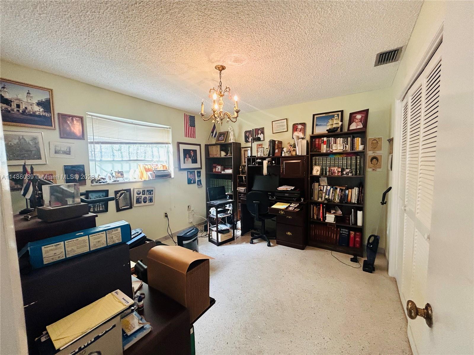 2311 Southwest 23rd Street Miami, FL 33145 - Photo 18 of 21 a work room with furniture and a chandelier