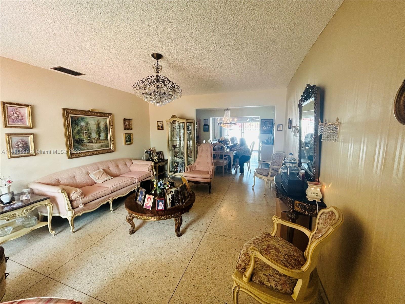2311 Southwest 23rd Street Miami, FL 33145 - Photo 4 of 21 a living room with patio furniture and a chandelier