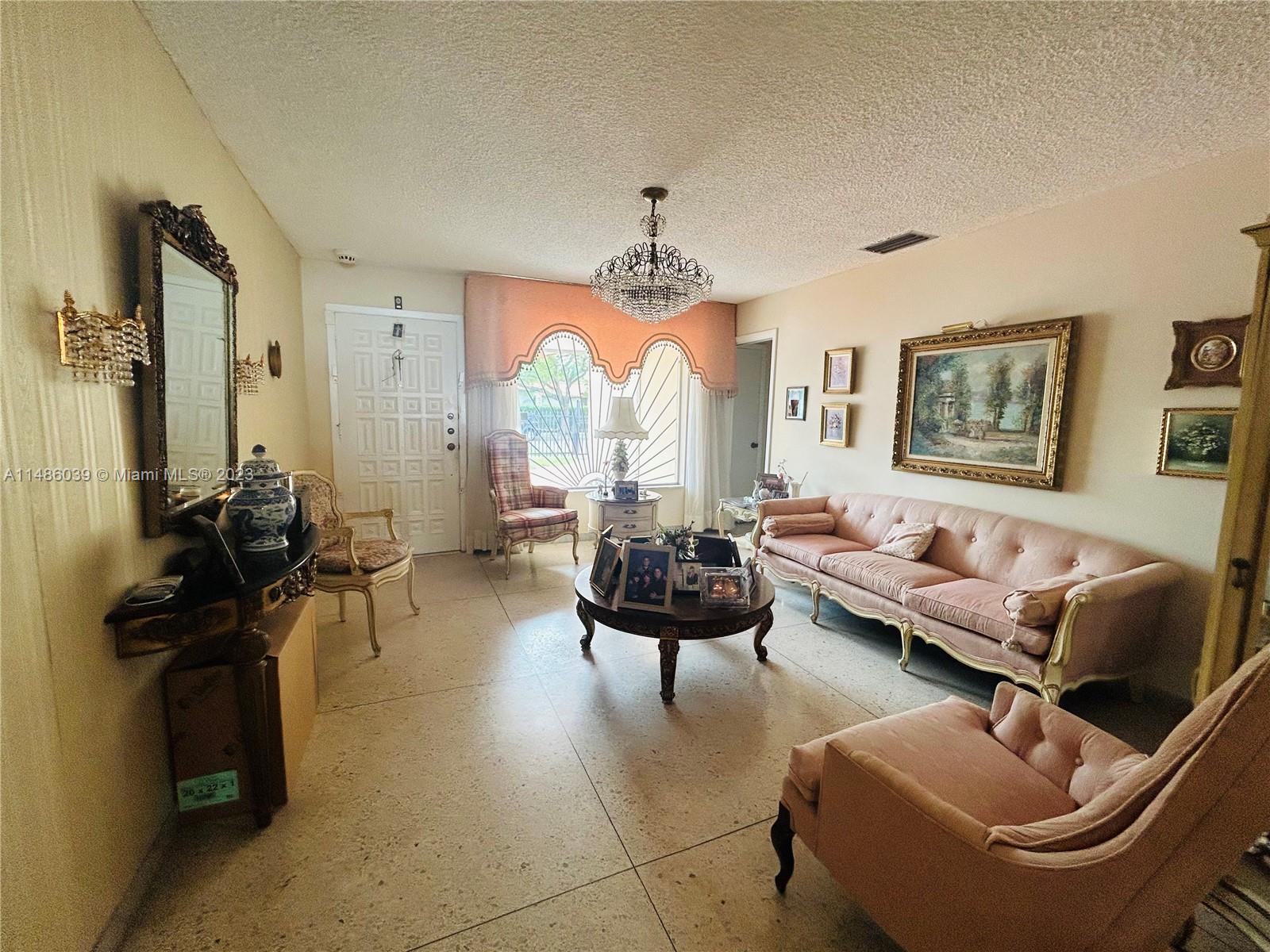 2311 Southwest 23rd Street Miami, FL 33145 - Photo 5 of 21 a living room with furniture and a chandelier