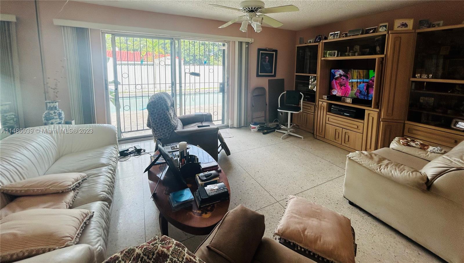2311 Southwest 23rd Street Miami, FL 33145 - Photo 7 of 21 a living room with furniture a flat screen tv and a fireplace