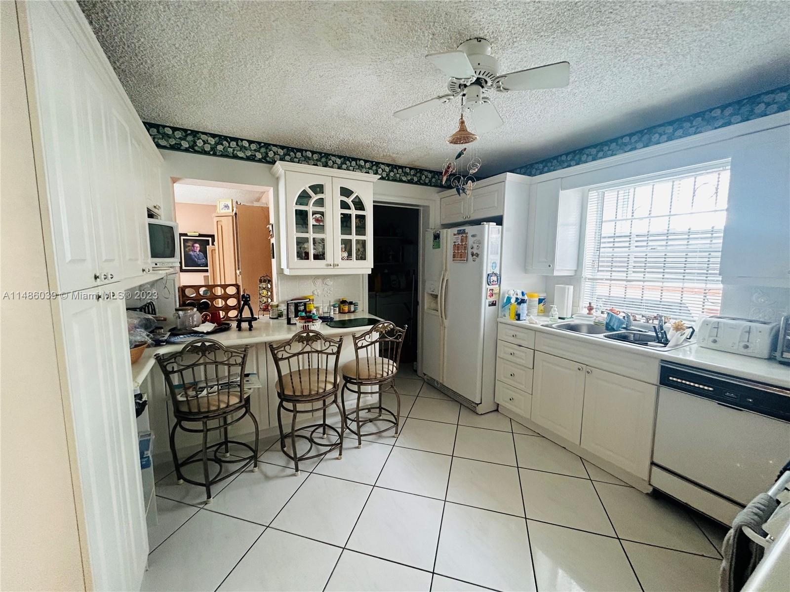 2311 Southwest 23rd Street Miami, FL 33145 - Photo 8 of 21 a kitchen with cabinets and chairs