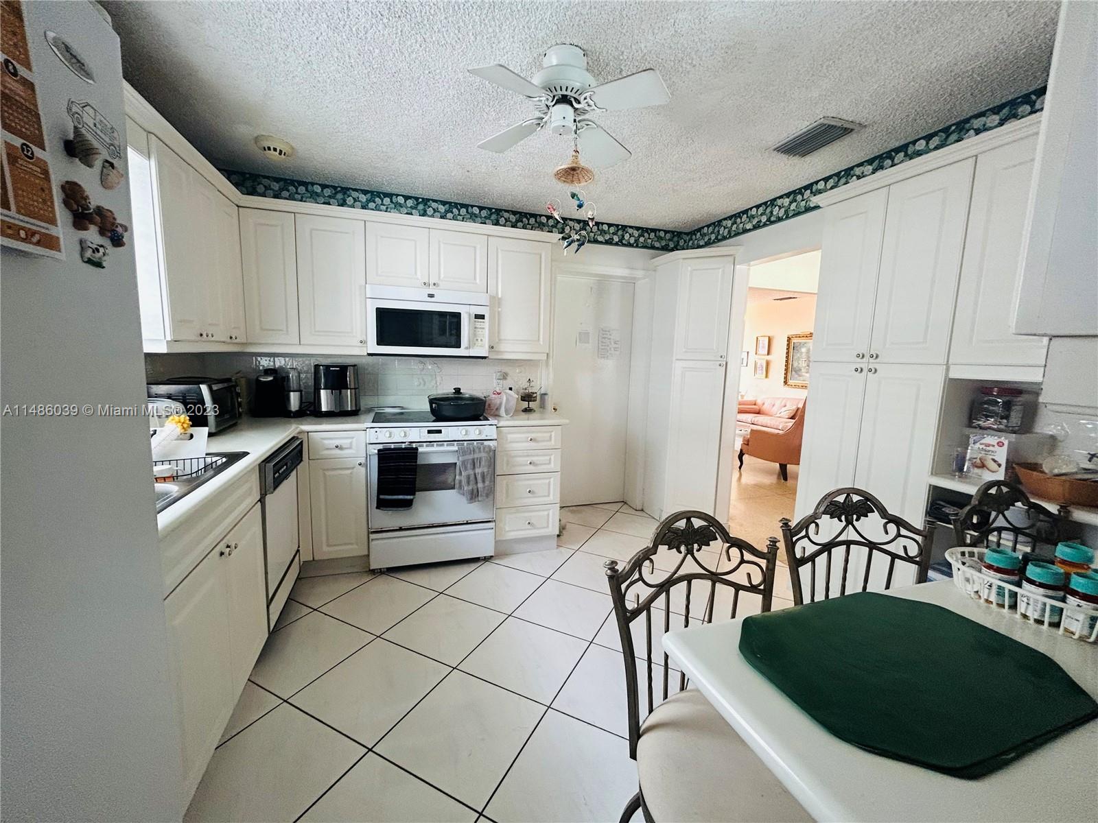 2311 Southwest 23rd Street Miami, FL 33145 - Photo 9 of 21 a kitchen with a sink a stove and cabinets