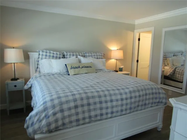 a bedroom with a bed and a lamp