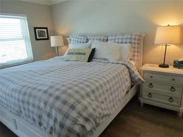 a bedroom with a bed and a lamp