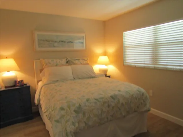 a large bed sitting in a bedroom next to a window