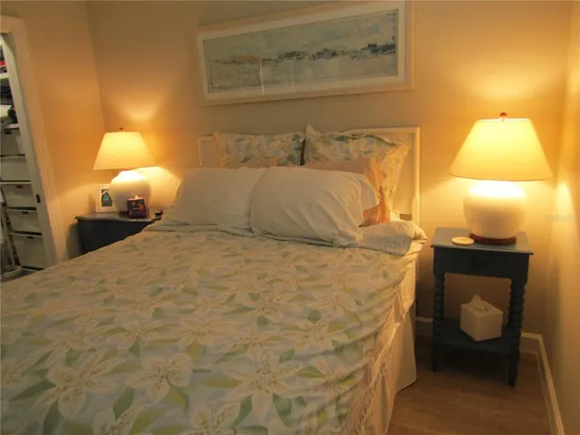 a bedroom with a bed and a lamp