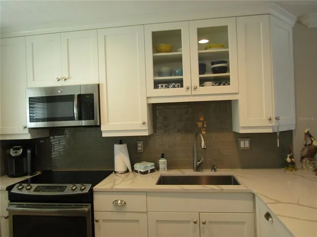 a kitchen with a sink and cabinets
