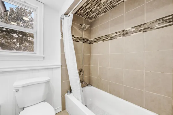 a bathroom with a toilet and a bathtub
