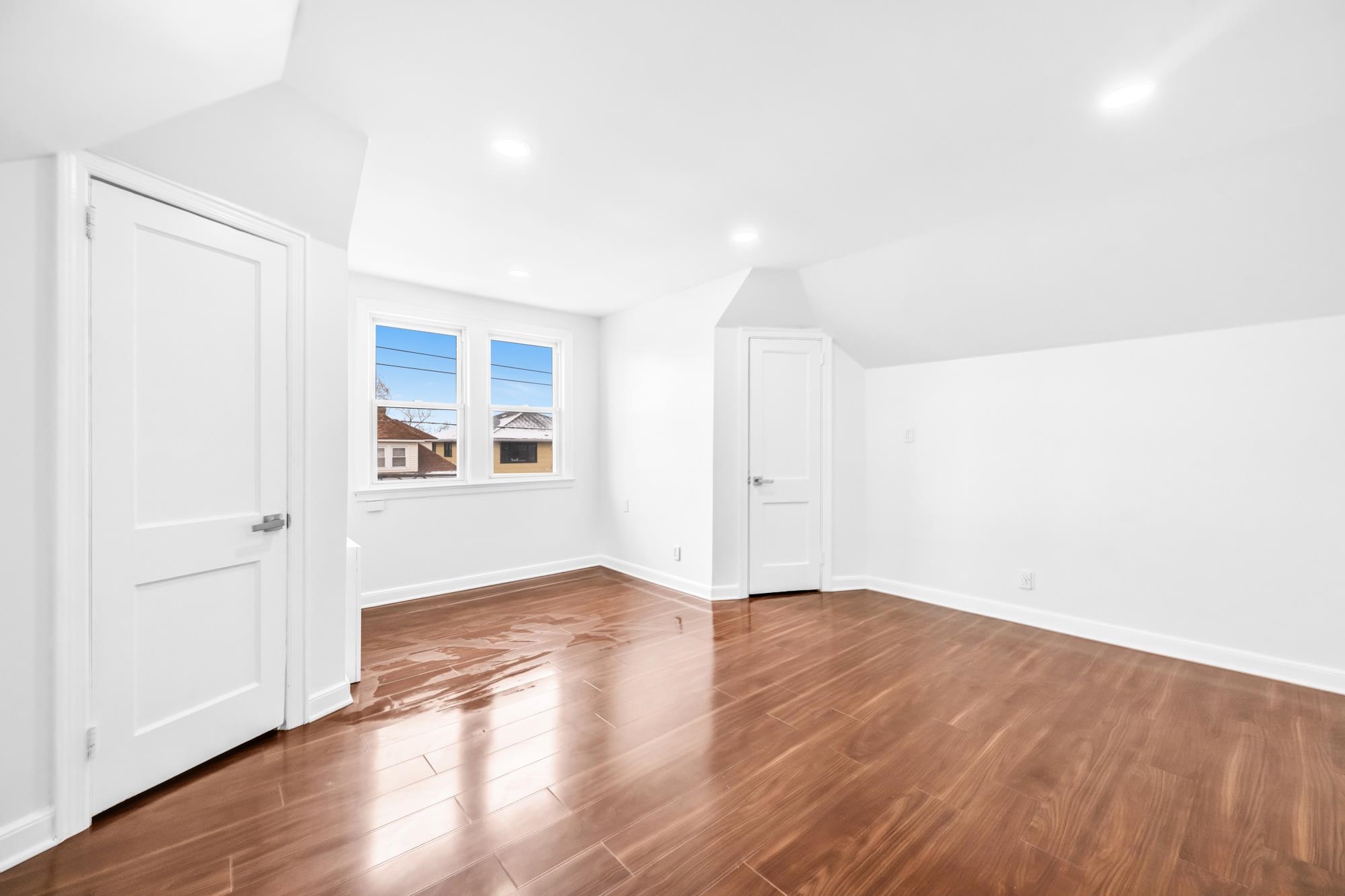 284 MacArthur Avenue, Unit 2 Garfield, NJ 07026 - Photo 13 of 19 an empty room with wooden floor and windows