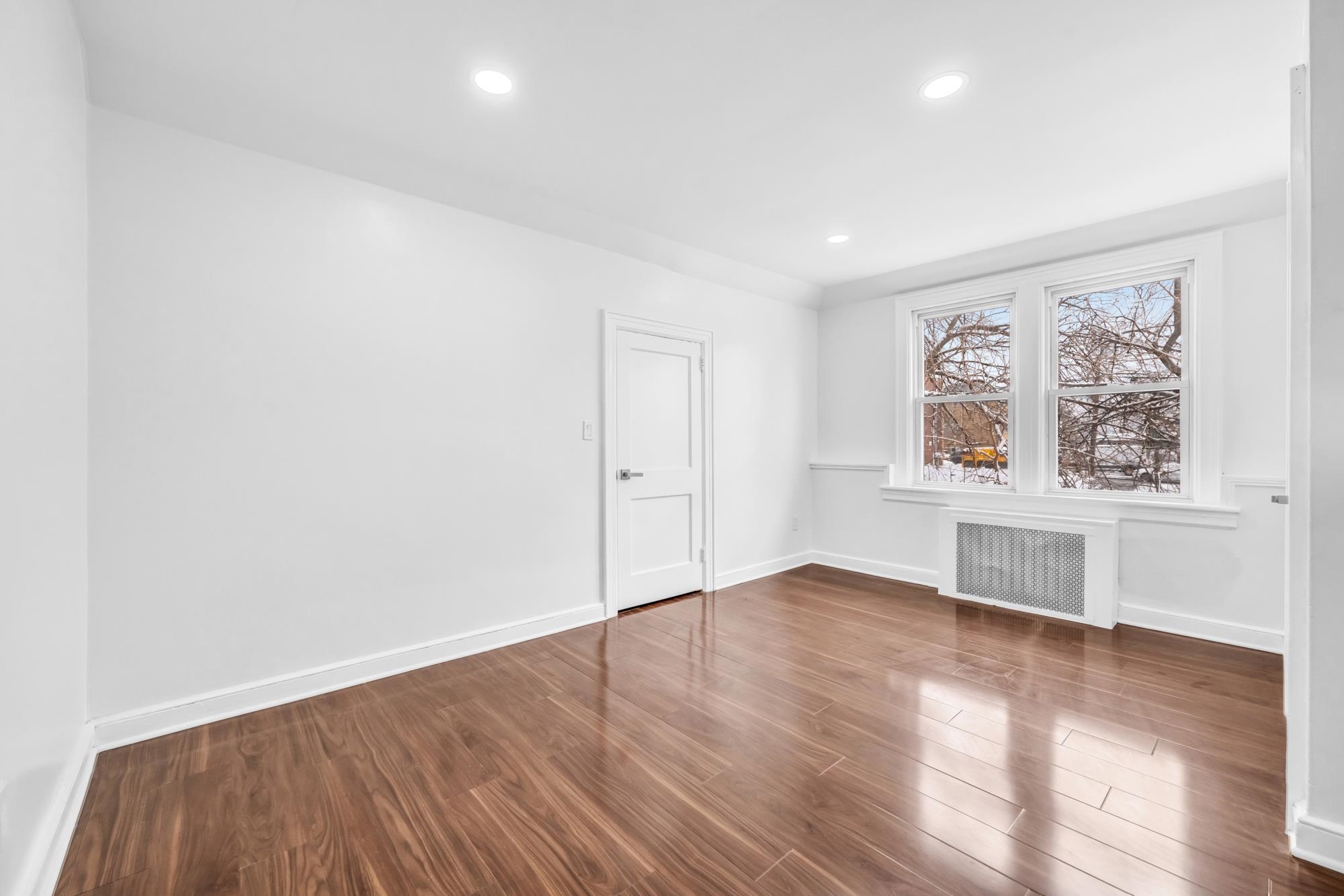 284 MacArthur Avenue, Unit 2 Garfield, NJ 07026 - Photo 15 of 19 an empty room with wooden floor and windows
