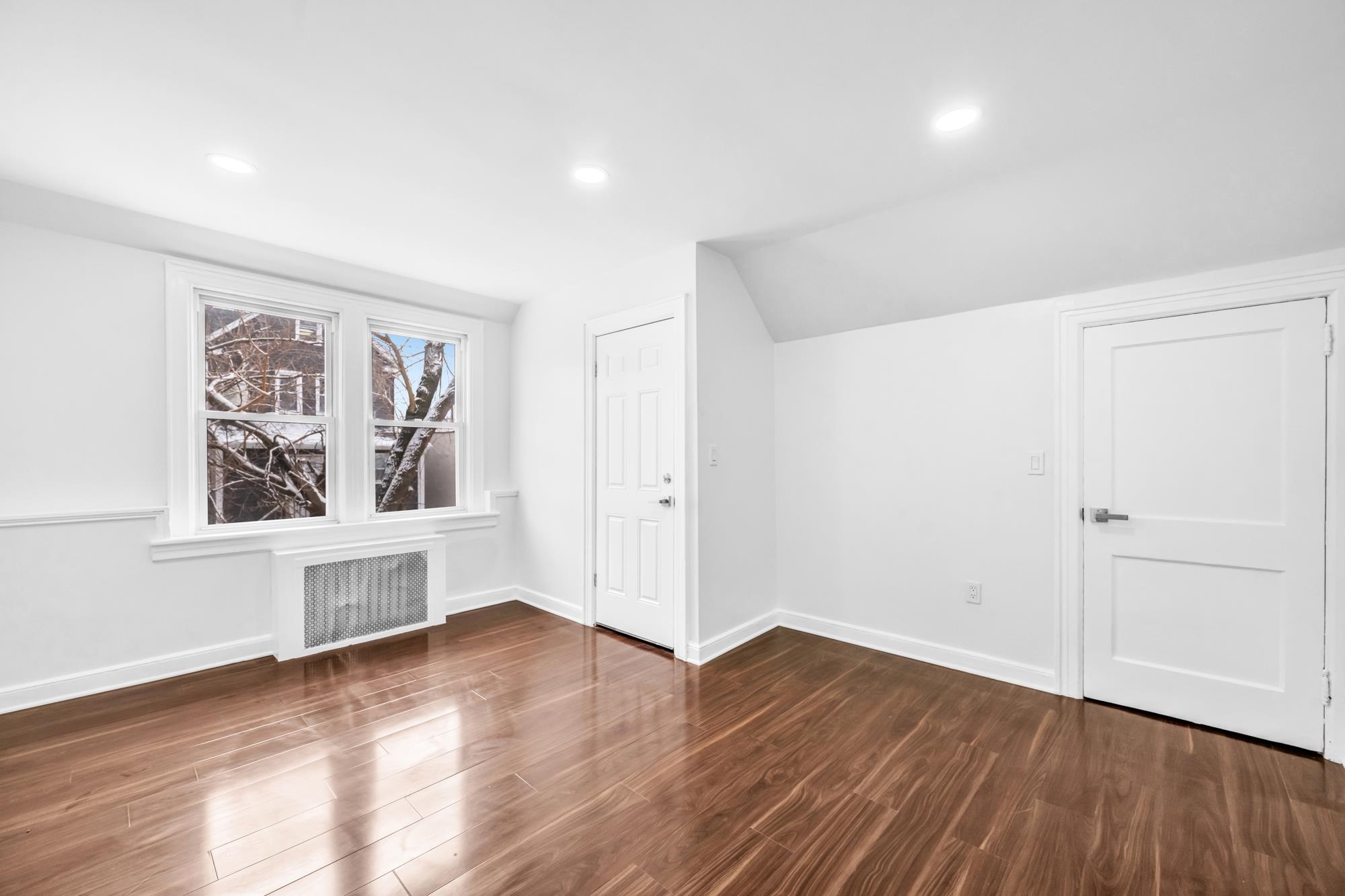 284 MacArthur Avenue, Unit 2 Garfield, NJ 07026 - Photo 16 of 19 wooden floor in an empty room with a window