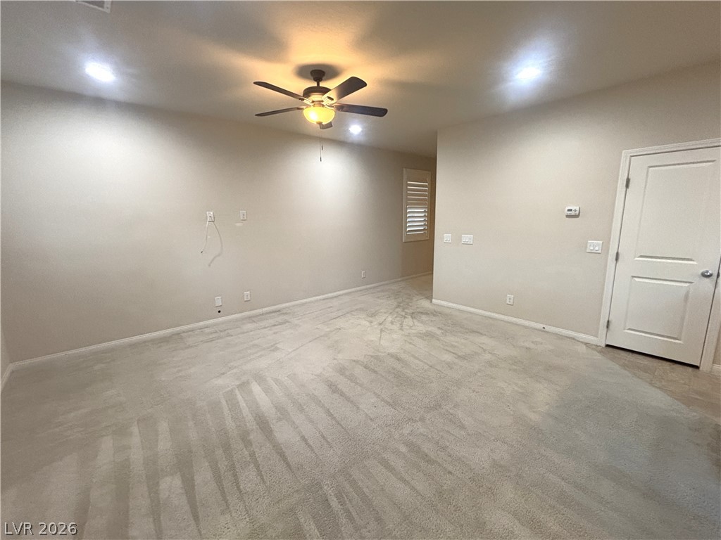 121 Elm Reed Avenue Las Vegas, NV 89113 - Photo 8 of 30 A versatile space ready for personalization, featuring recessed lighting and plush carpeting.