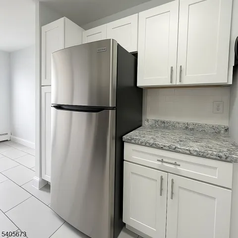 a white refrigerator freezer sitting inside of a kitchen