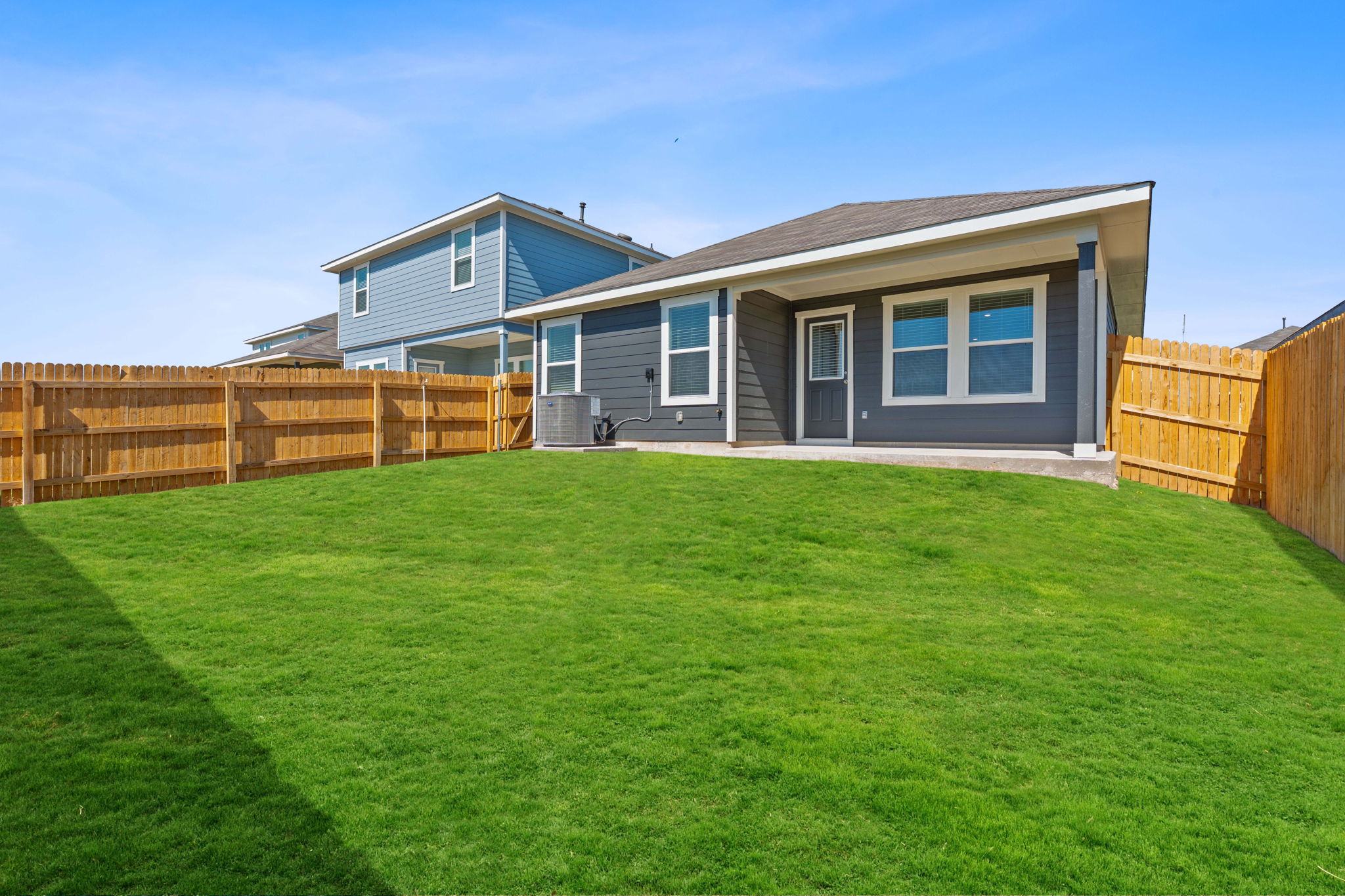 13309 Mancos Shale Road Mustang Ridge, TX 78610 - Photo 16 of 19 a view of a house with a yard and sitting area