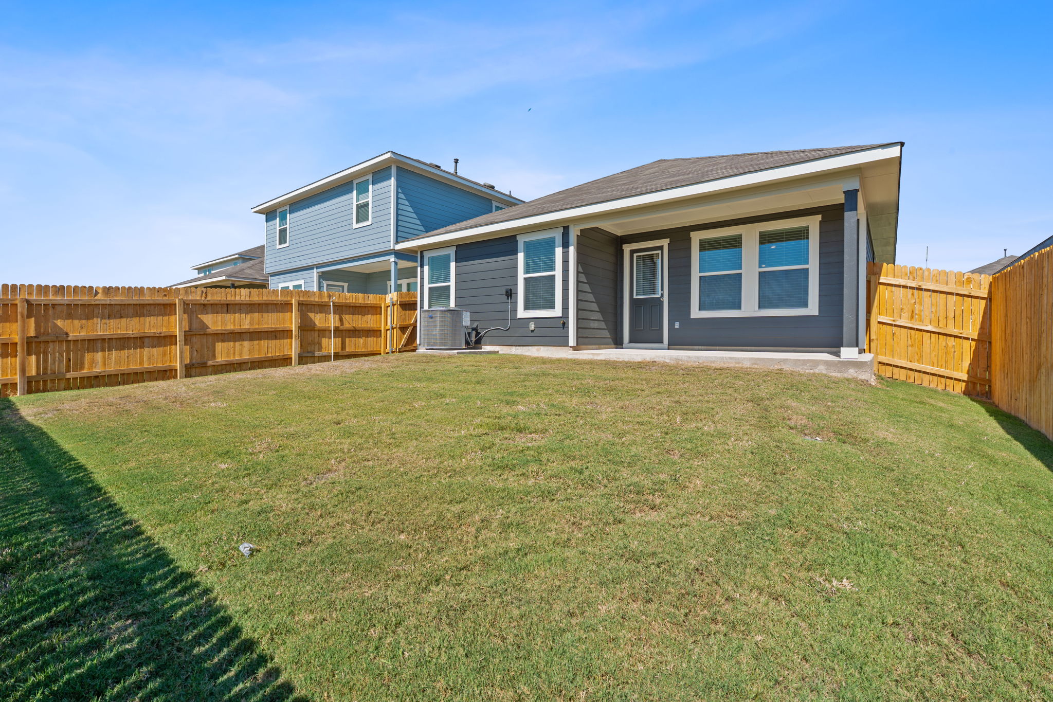 13309 Mancos Shale Road Mustang Ridge, TX 78610 - Photo 18 of 19 a view of a house with a backyard