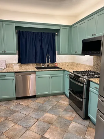 a kitchen with stainless steel appliances and sink