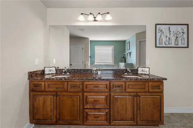 a bathroom with a sink vanity and mirror