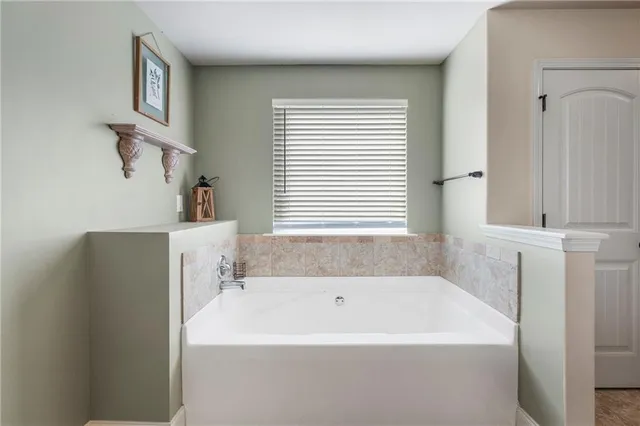 a white bath tub sitting next to a window