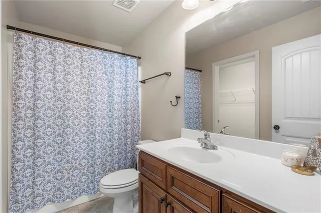 a bathroom with a sink toilet and a mirror