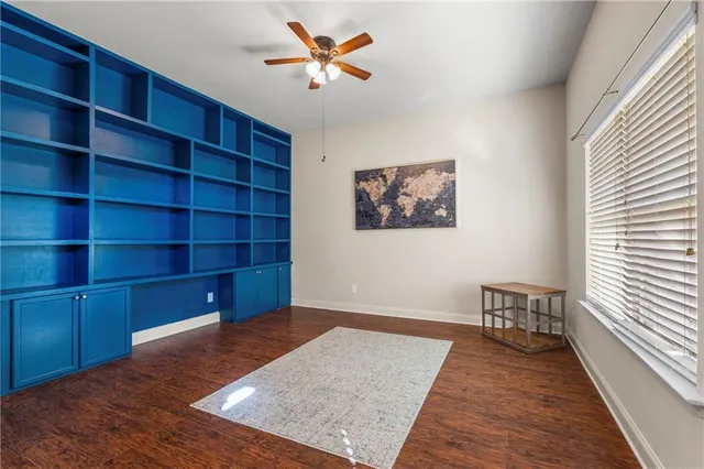 a view of a room with wooden floor and cabinet