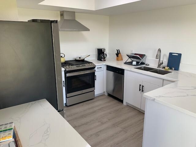 49058 Wayne Street Indio, CA 92201 - Photo 21 of 26 a kitchen with a stove and a wooden floor