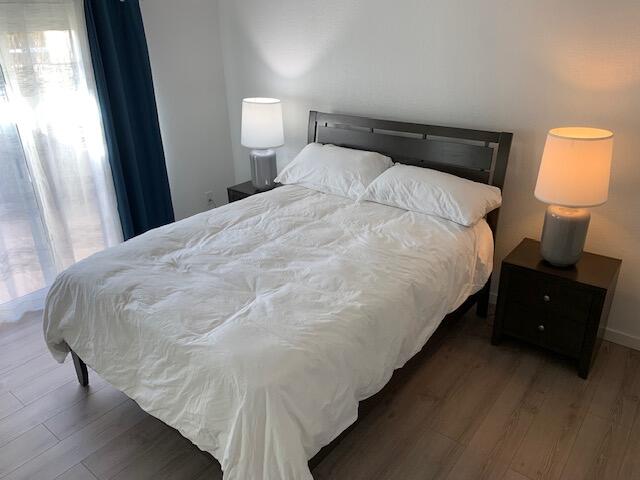 49058 Wayne Street Indio, CA 92201 - Photo 24 of 26 a large bed sitting in a bedroom next to a lamp