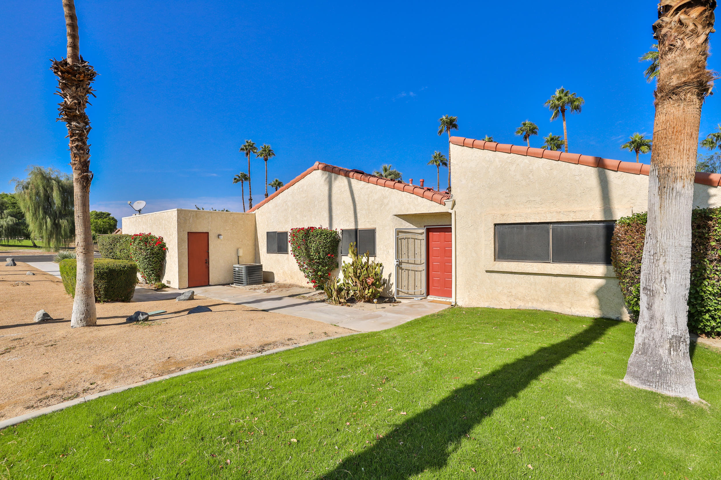 49058 Wayne Street Indio, CA 92201 - Photo 7 of 26 a view of a house with a yard and tree s