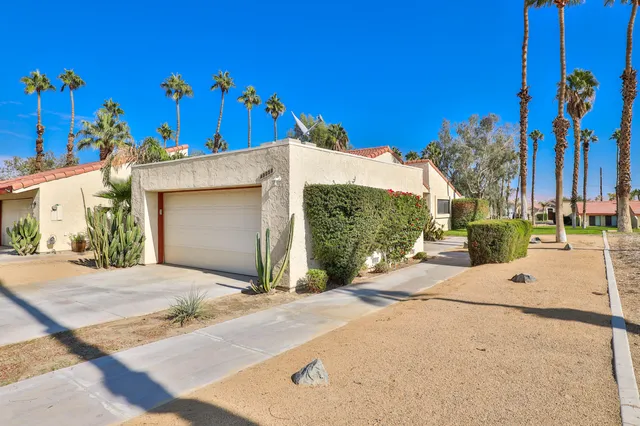 a view of a house with a yard and garage