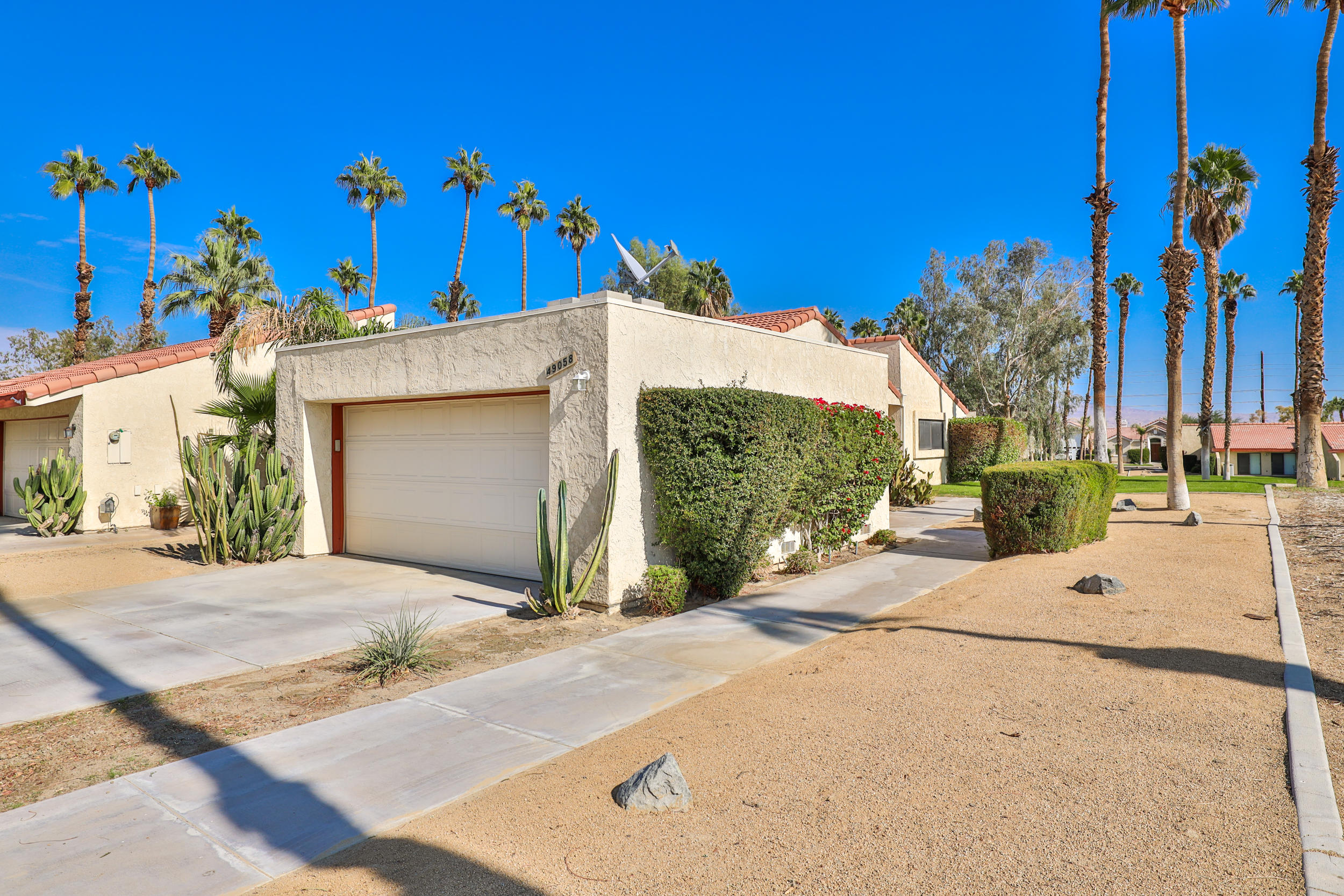 49058 Wayne Street Indio, CA 92201 - Photo 8 of 26 a view of a house with a yard and garage