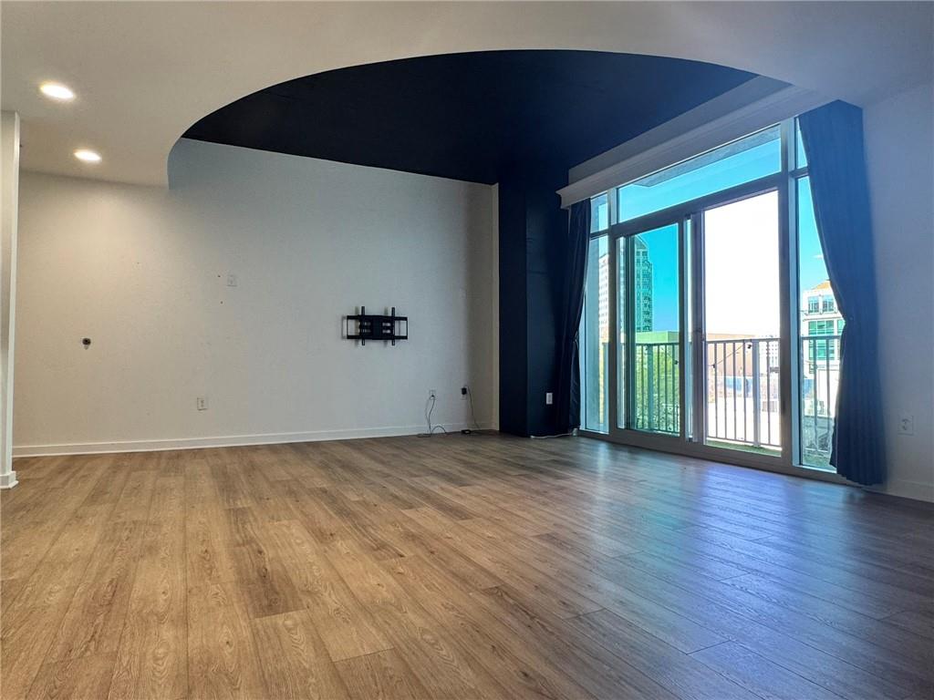 250 Pharr Road Northeast, Unit 601 Atlanta, GA 30305 - Photo 10 of 34 a view of an empty room with wooden floor and a window