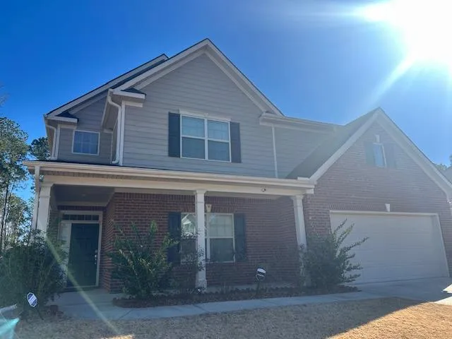 a front view of a house with garden