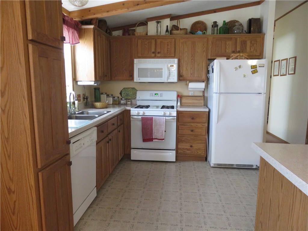 206 Sunbury Road Slippery Rock, PA 16057 - Photo 11 of 24 Light and bright kitchen with oak cabinets, white appliances and a pantry.