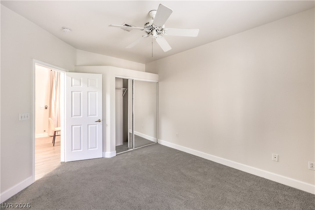 2050 West Warm Springs Road, Unit 1421 Henderson, NV 89014 - Photo 30 of 45 A spacious bedroom features plush carpeting and a convenient mirrored closet.