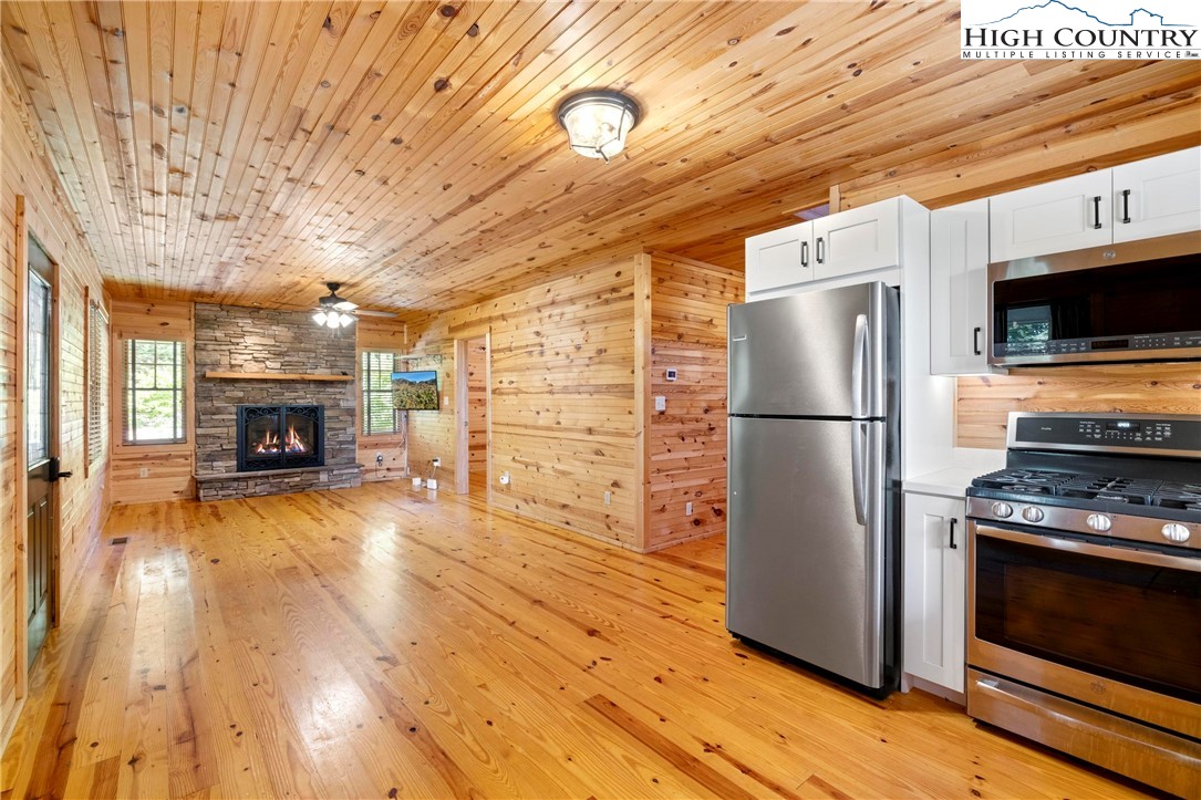207 Carters Lane Purlear, NC 28665 - Photo 11 of 50 a kitchen with granite countertop a refrigerator and a stove top oven
