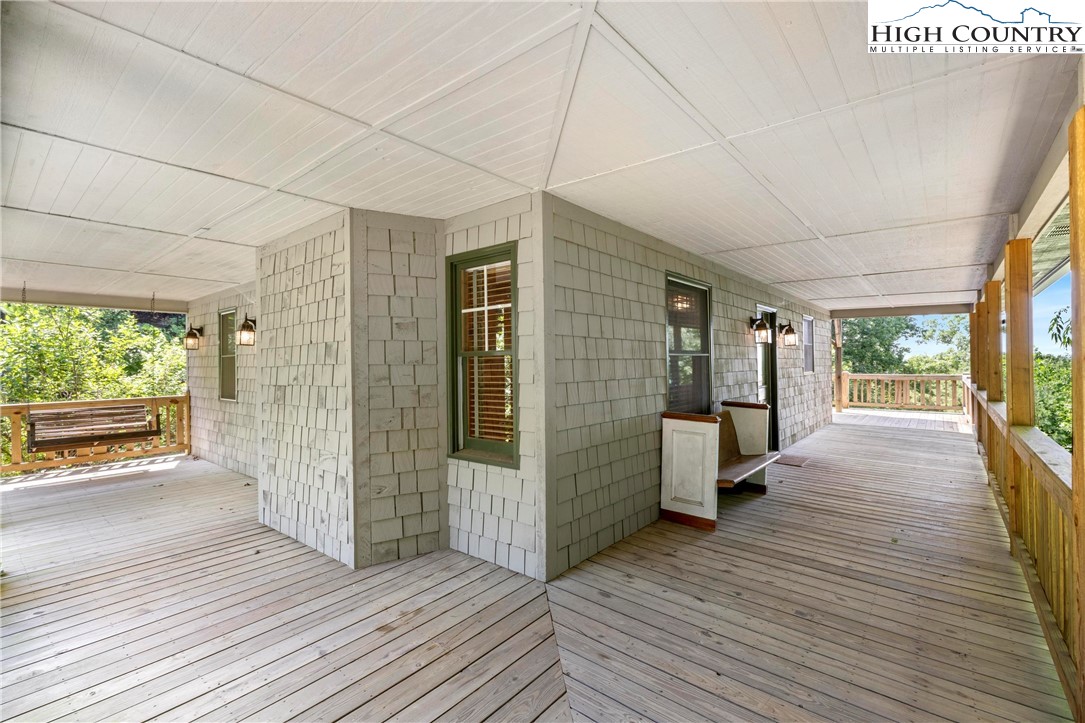 207 Carters Lane Purlear, NC 28665 - Photo 3 of 50 a view of a patio outdoor space with wooden floor and windows