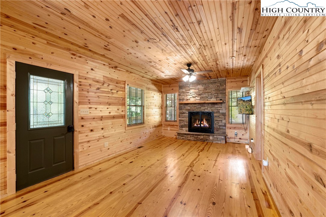207 Carters Lane Purlear, NC 28665 - Photo 6 of 50 a view of empty room with wooden floor and fireplace