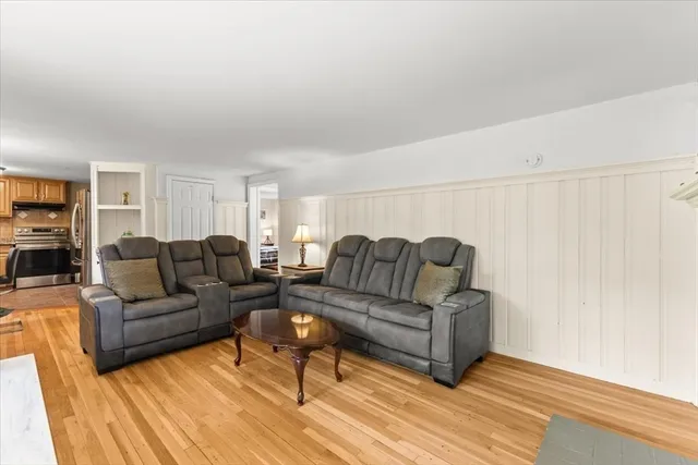 a living room with couches and a coffee table with wooden floor