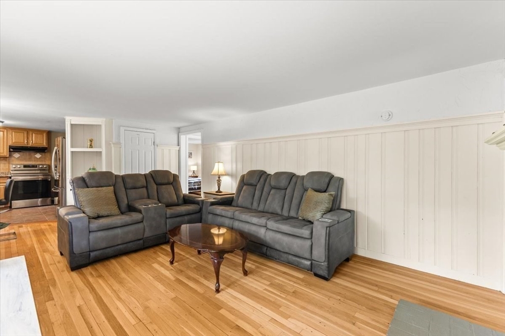 85 Maple Street Bourne, MA 02532 - Photo 12 of 42 a living room with couches and a coffee table with wooden floor