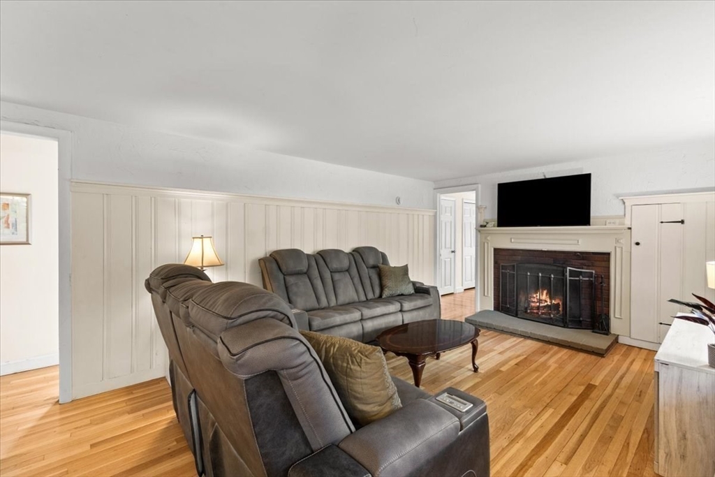 85 Maple Street Bourne, MA 02532 - Photo 13 of 42 a living room with furniture a fireplace and a flat screen tv
