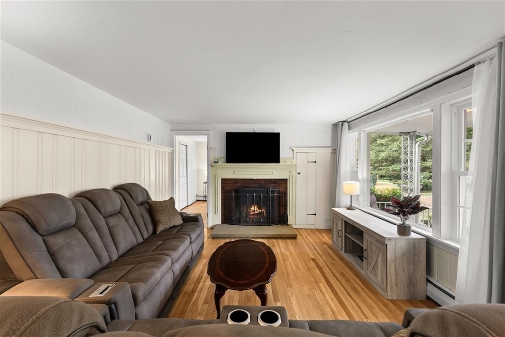 85 Maple Street Bourne, MA 02532 - Photo 14 of 42 a living room with furniture and a fireplace