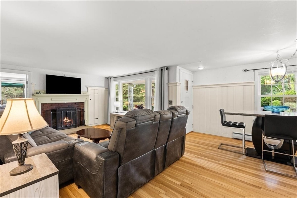 85 Maple Street Bourne, MA 02532 - Photo 15 of 42 a living room with furniture a fireplace and a flat screen tv