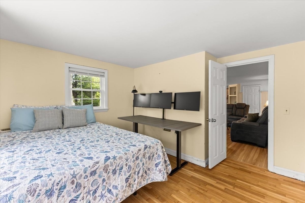 85 Maple Street Bourne, MA 02532 - Photo 18 of 42 a bedroom with a bed and wooden floor