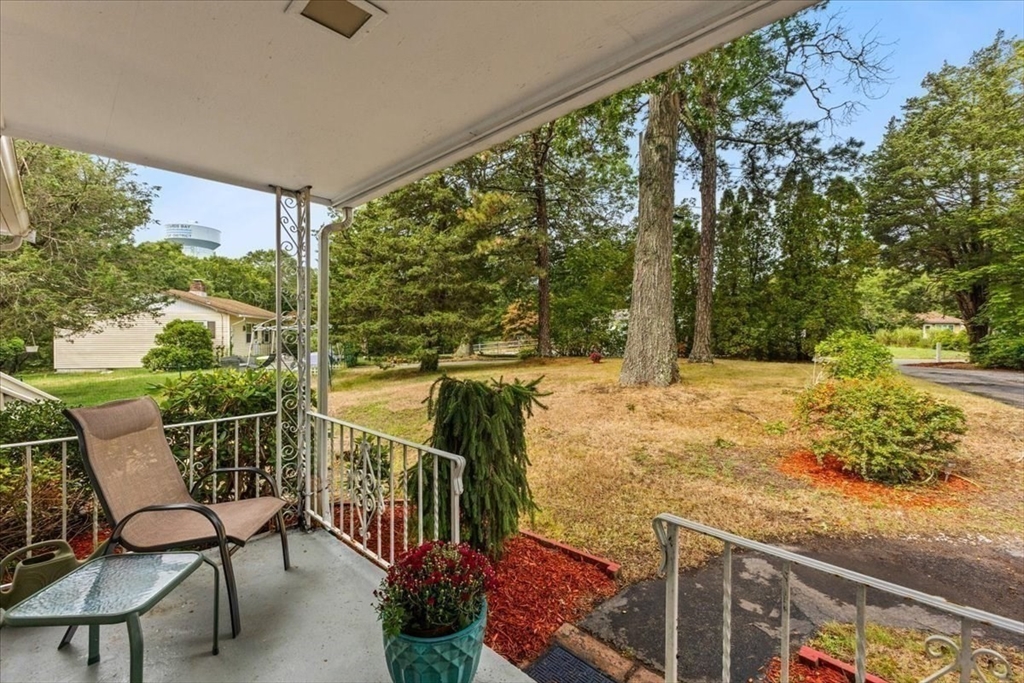 85 Maple Street Bourne, MA 02532 - Photo 2 of 42 a view of a balcony with chair and wooden fence