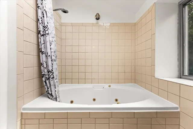 a bathroom with a bathtub and shower