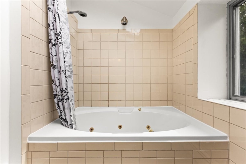 85 Maple Street Bourne, MA 02532 - Photo 21 of 42 a bathroom with a bathtub and shower